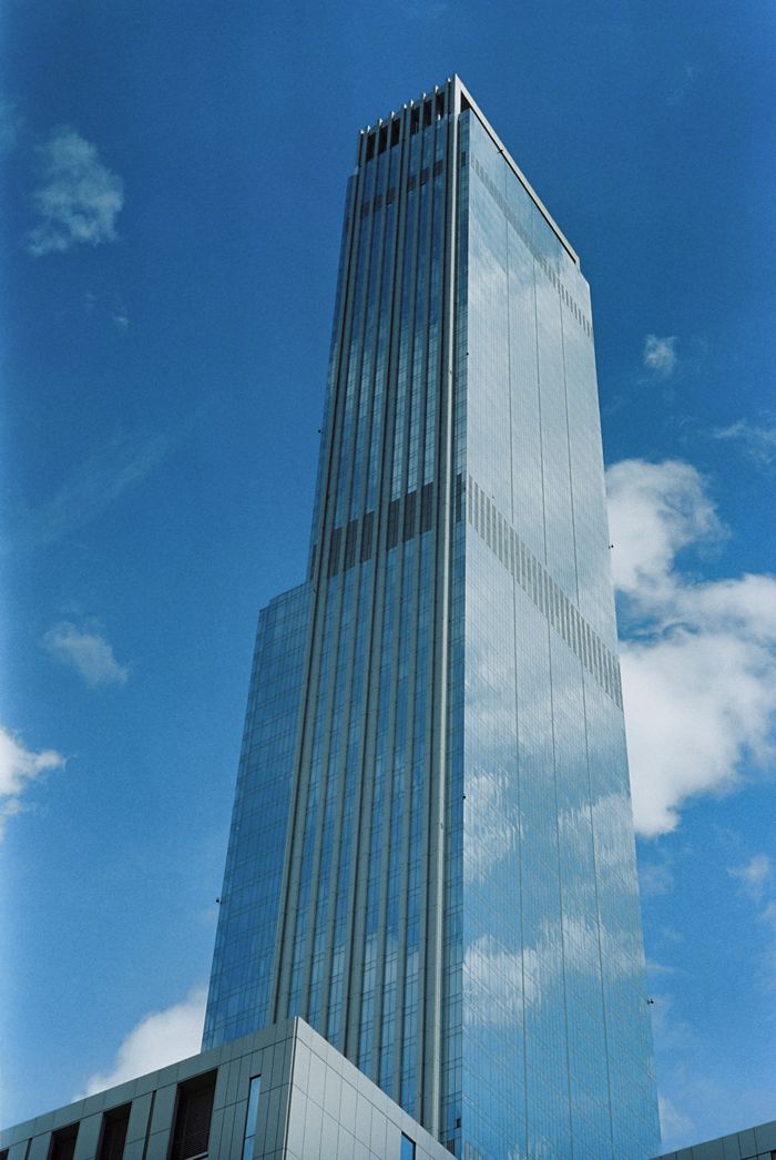 The Art of Drawing Readers In: Your attractive post title goes here A striking modern skyscraper in Astana, Kazakhstan, set against a clear blue sky.