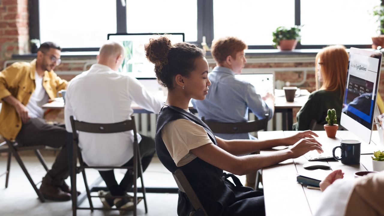 Mastering the First Impression: Your intriguing post title goes here A diverse group of professionals working together in a modern office environment, focused on teamwork.