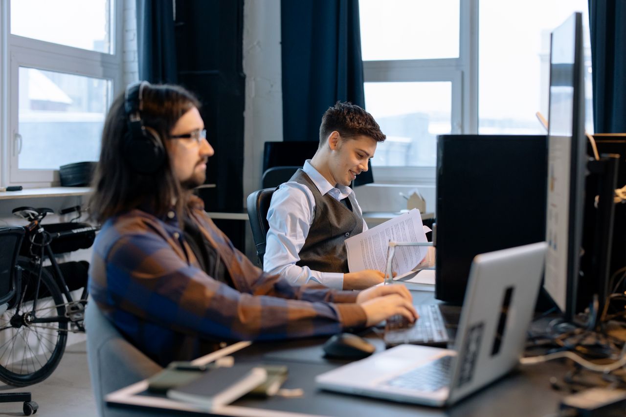 Crafting Captivating Headlines: Your awesome post title goes here Two men collaborating in a modern office setting, focusing on teamwork and productivity.